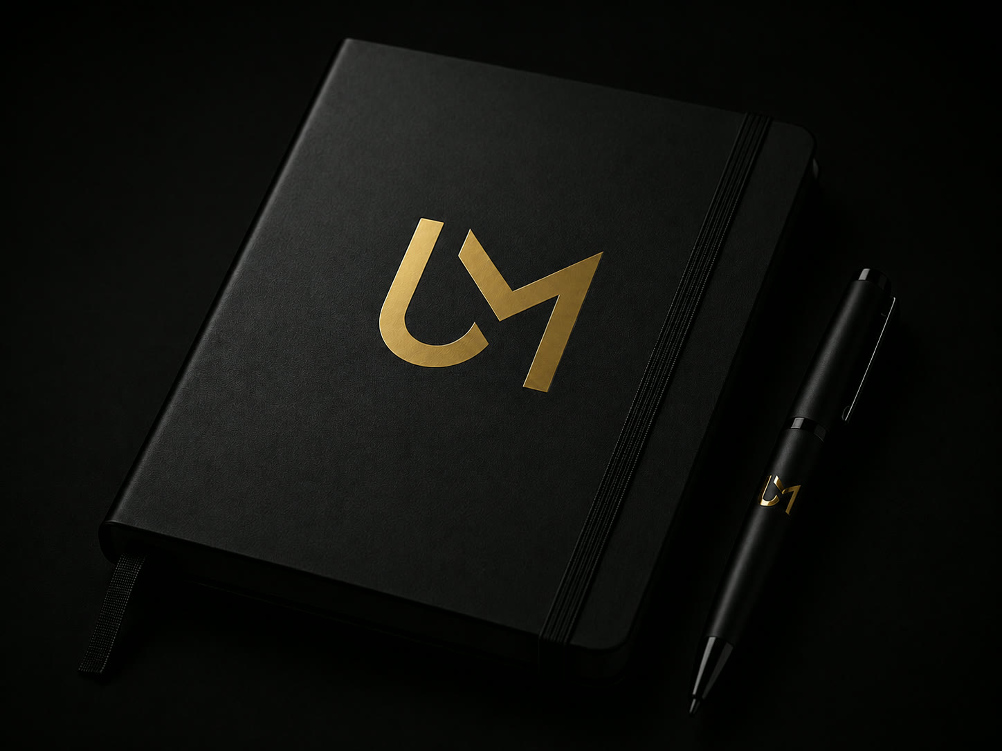 UM Capital branded notebook and pen