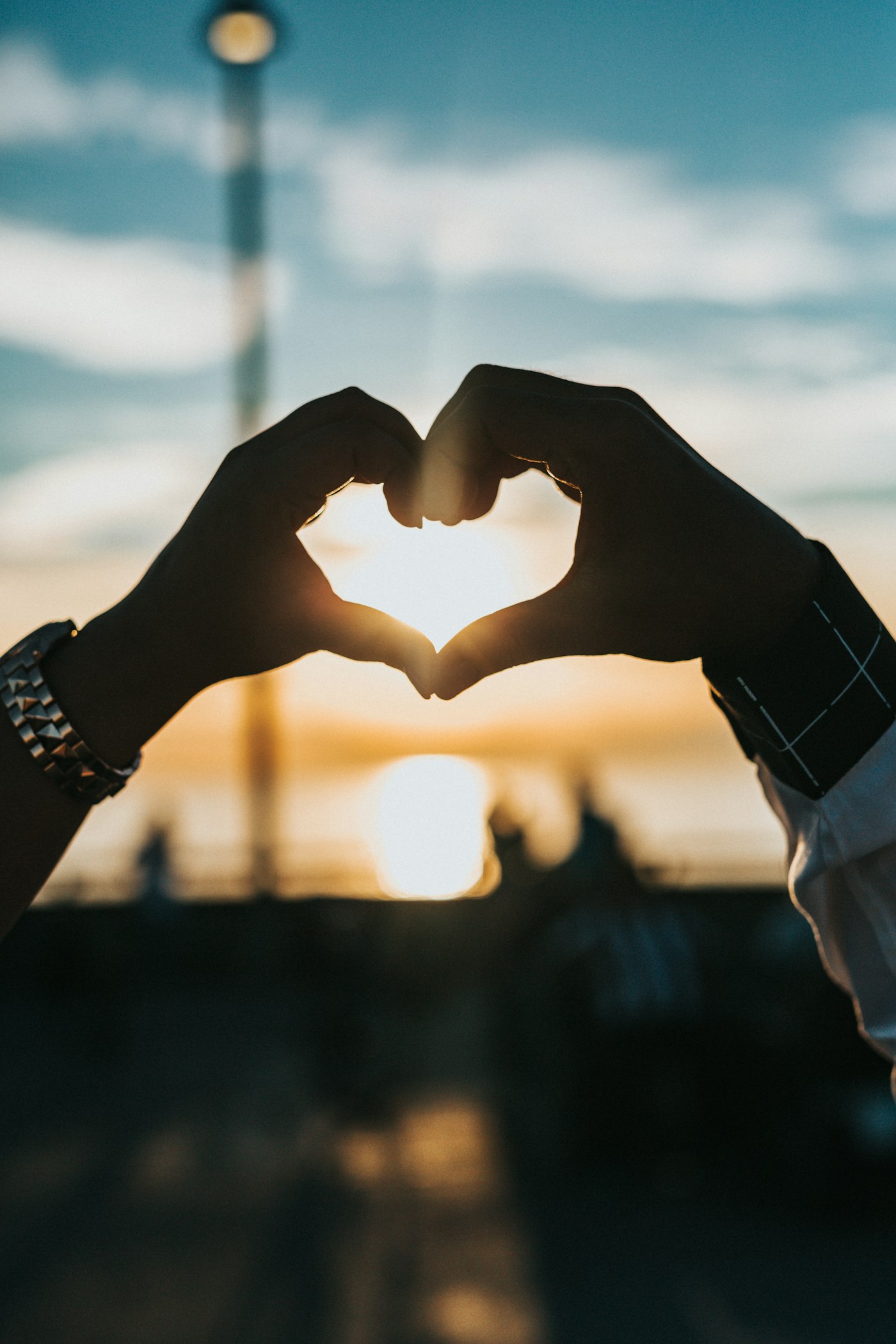 Couple holding hands at sunset